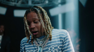 a man with dreadlocks standing in a room