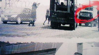 a black and white photo of a truck and some people