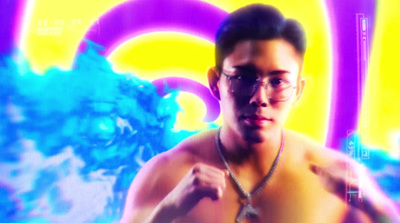 a shirtless man wearing glasses and a necklace