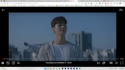 a young man standing in front of a city skyline