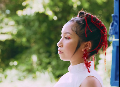 a woman with a red tie around her hair