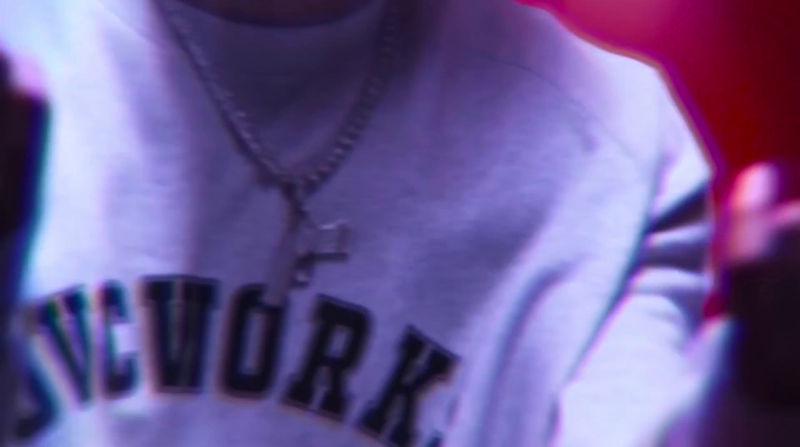 a close up of a person wearing a necklace