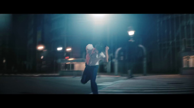 a blurry photo of a person walking on a street at night