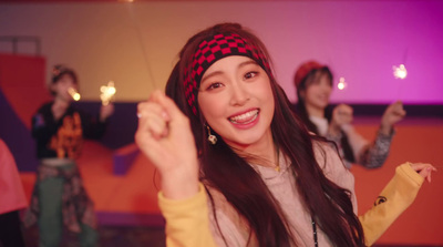 a woman with long hair wearing a red and black checkered headband