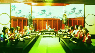 a group of people sitting at a long table