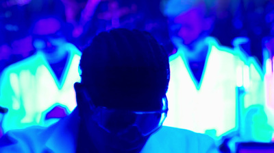 a man in a white shirt and tie in a dark room