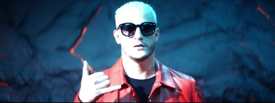 a man with white hair wearing sunglasses and a red jacket