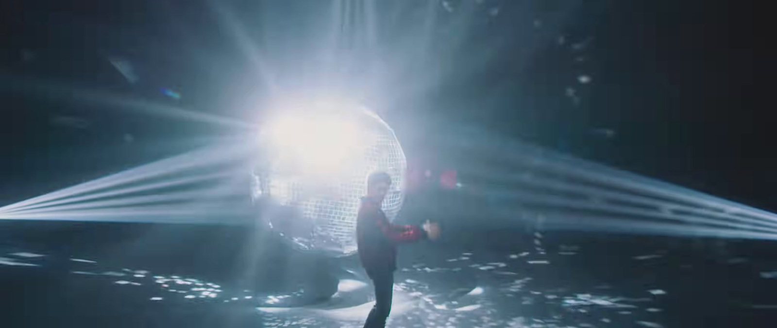 a person standing in front of a disco ball