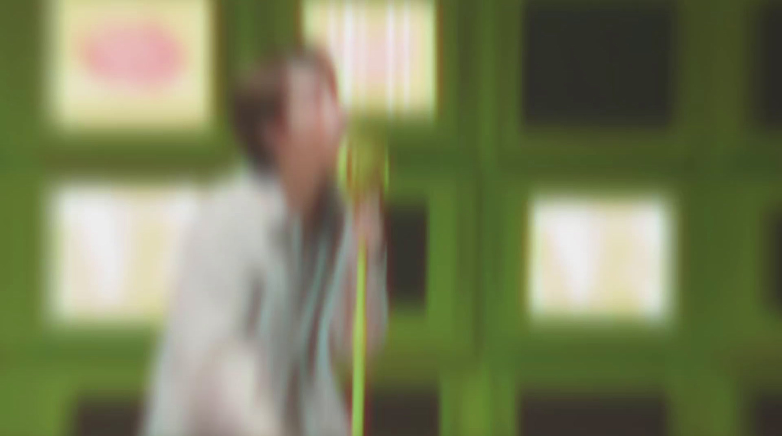 a blurry photo of a man in a white shirt