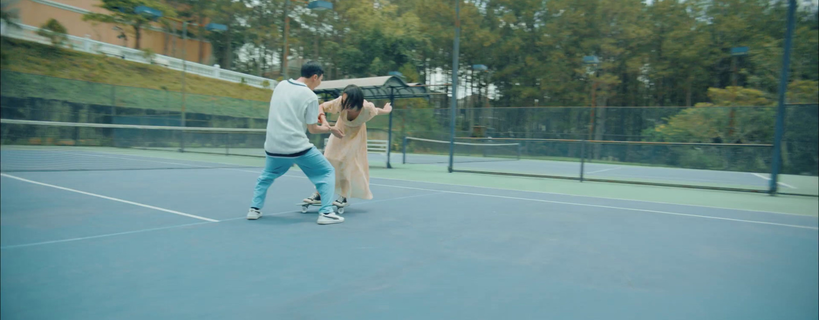 a man and a woman playing tennis on a tennis court