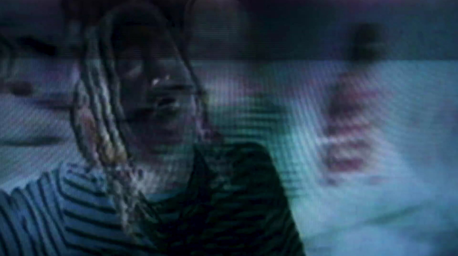 a blurry image of a woman with dreadlocks