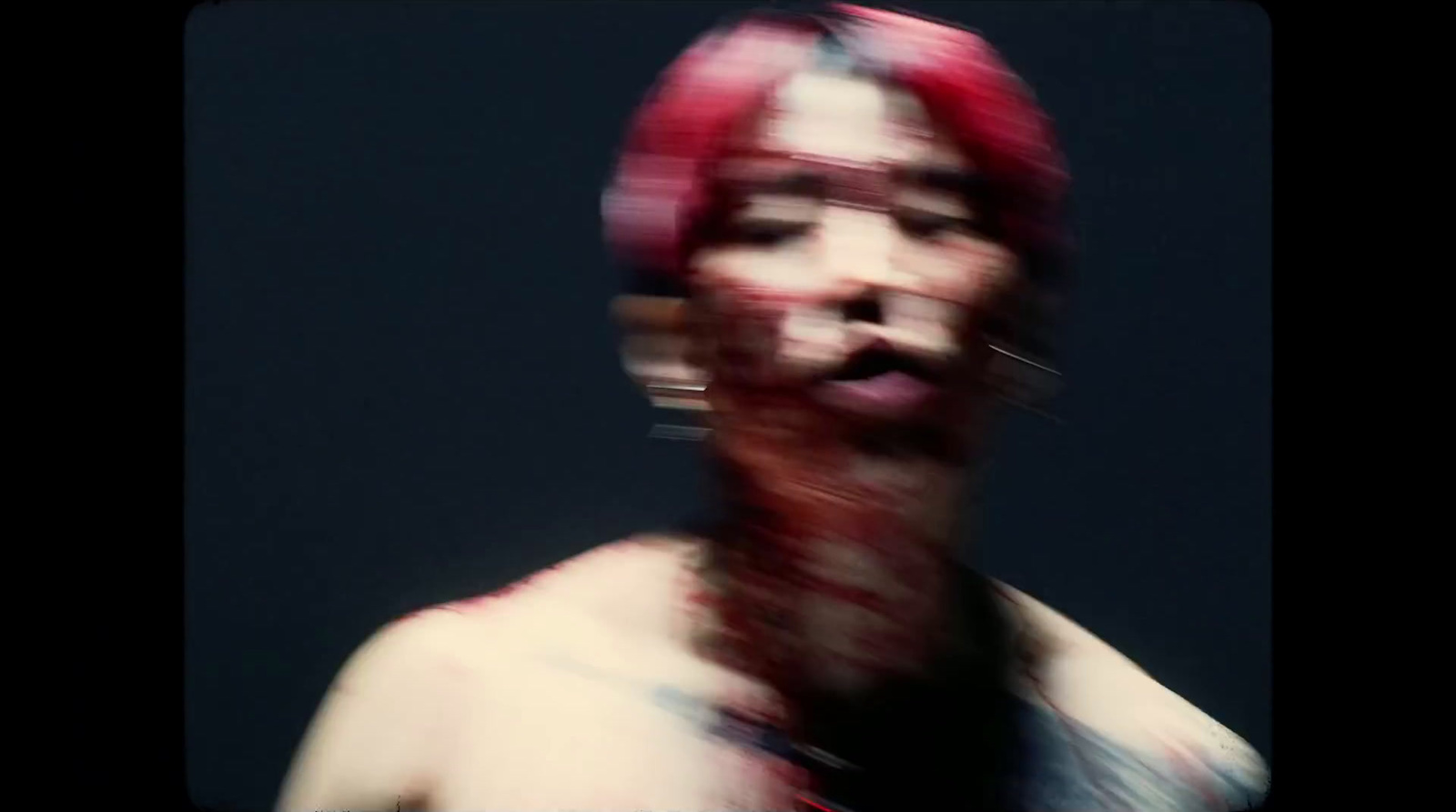 a blurry photo of a man with red hair