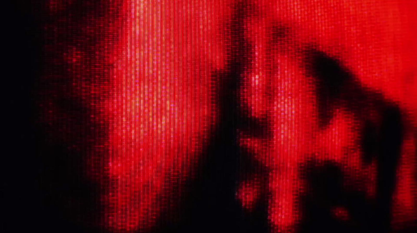 a blurry image of a person's face in red