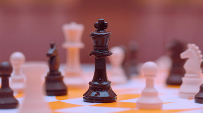 a close up of a chess board with pieces on it