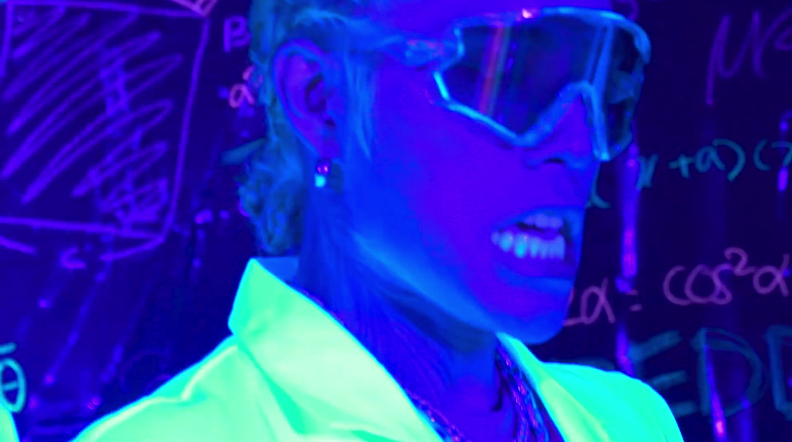 a woman wearing glasses and a neon shirt