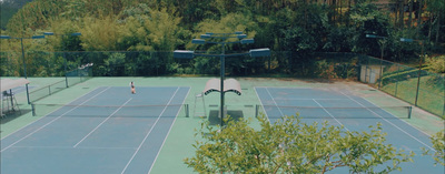 a tennis court with two people playing tennis