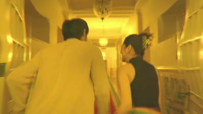 a man and a woman walking down a hallway