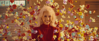 a woman in a red dress surrounded by butterflies