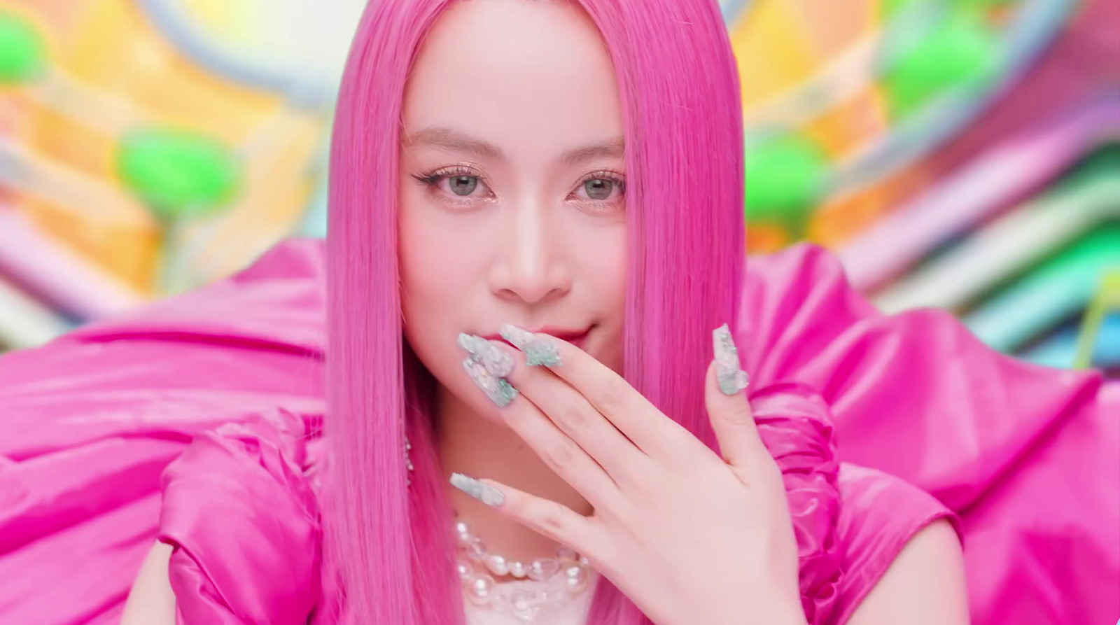 a woman with pink hair and silver nails