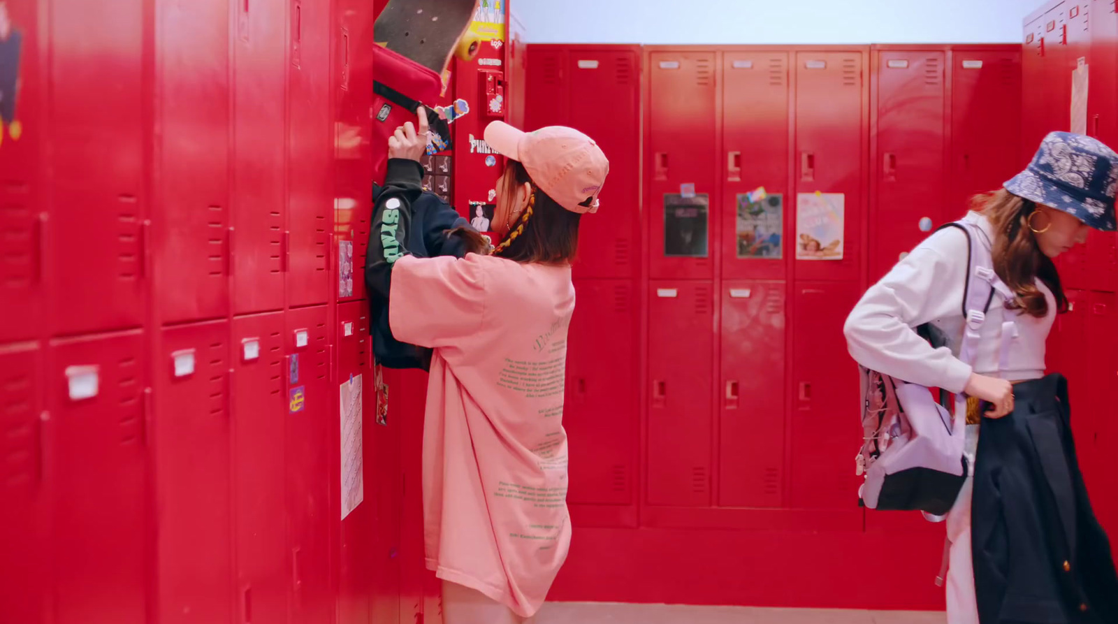 a couple of women standing next to each other near lockers