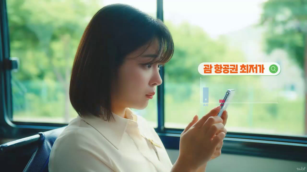 a woman sitting on a bus looking at her cell phone