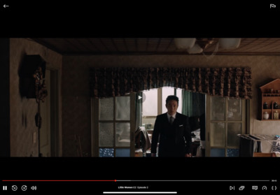 a man standing in a kitchen next to a window