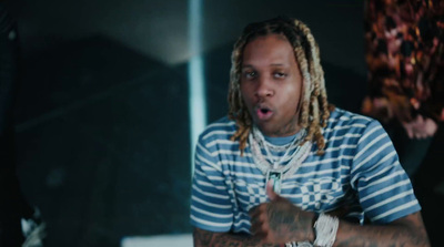 a man with dreadlocks sitting at a table