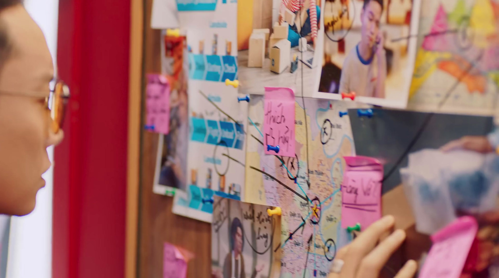 a woman is looking at a bulletin board