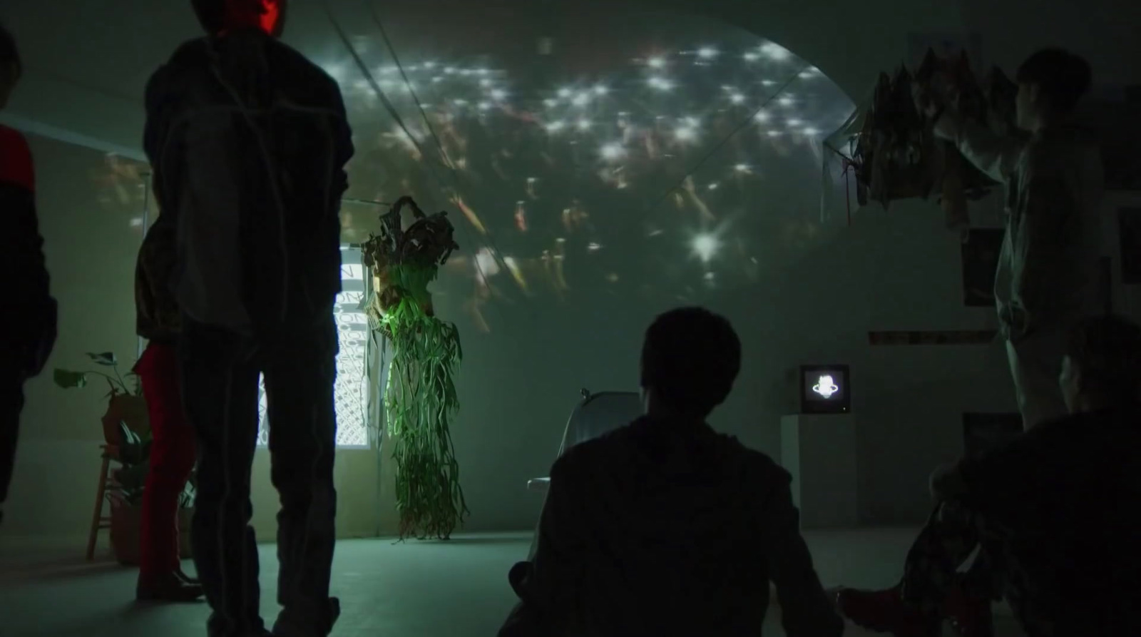 a group of people standing in a dark room