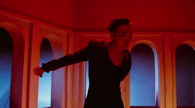 a woman standing in a room with a red light