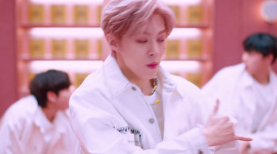 a man in a lab coat pointing at something