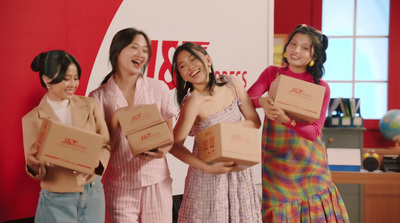 a group of young women holding boxes and laughing