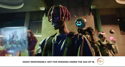 a man with dreadlocks standing next to a robot