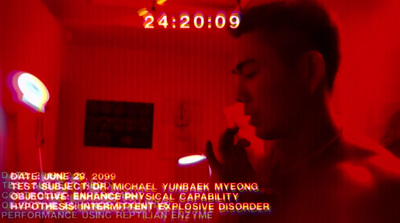 a man standing in a room with a red light