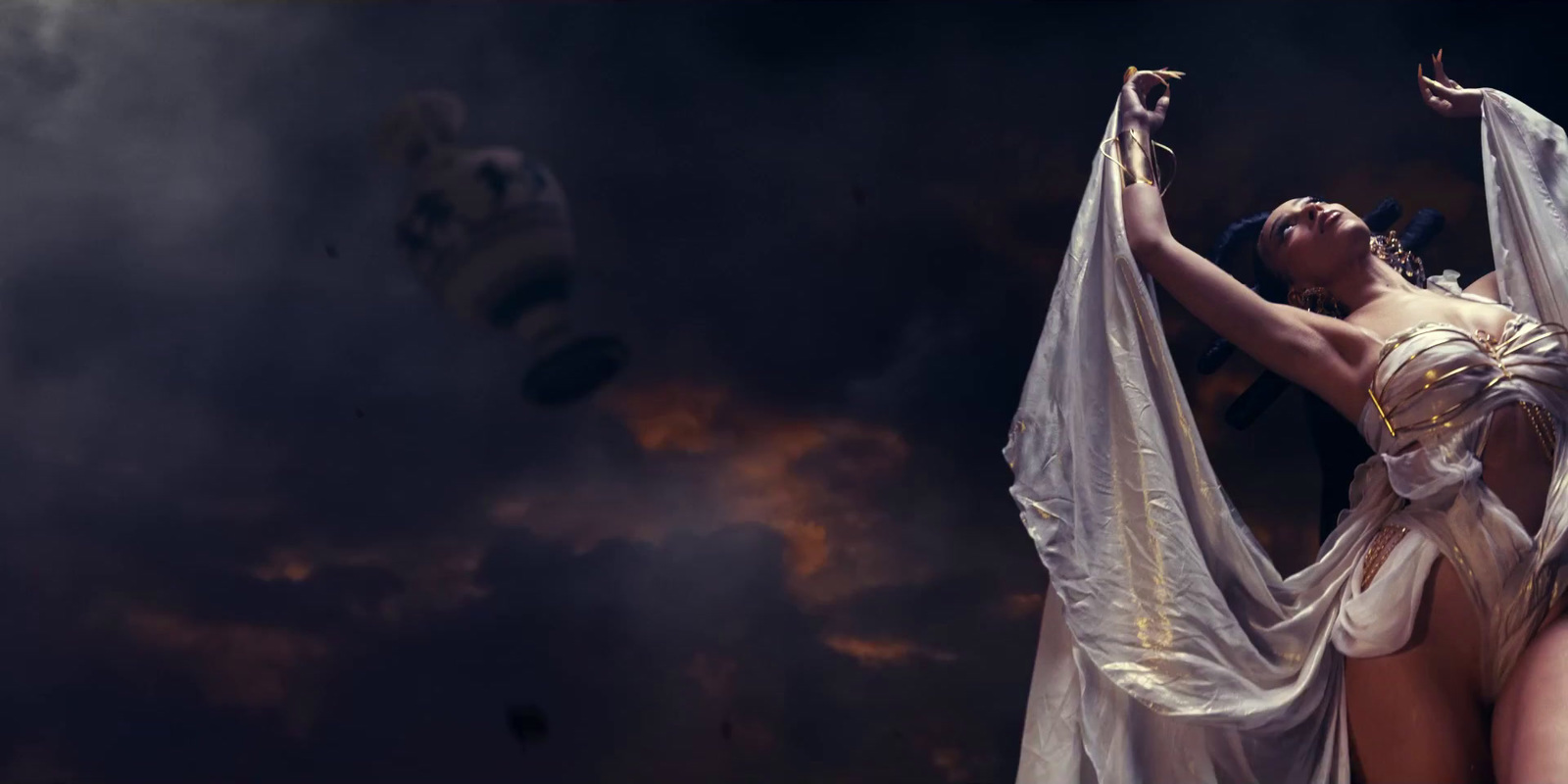 a woman in a white dress is holding a white cloth