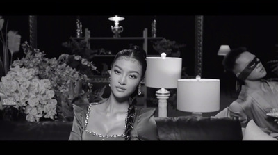 a woman sitting on a couch next to a lamp