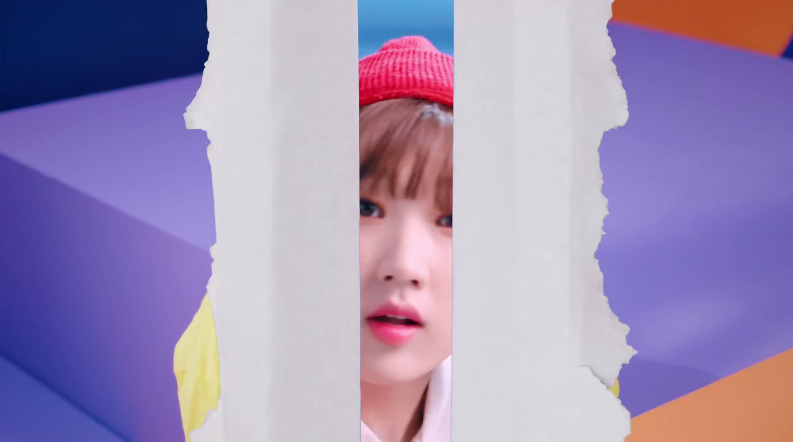 a girl with a pink hat looking through a hole in a piece of paper