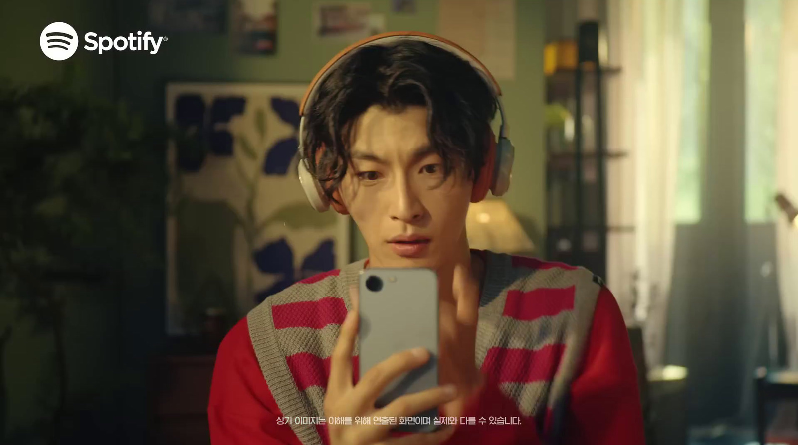 a man with headphones on taking a selfie