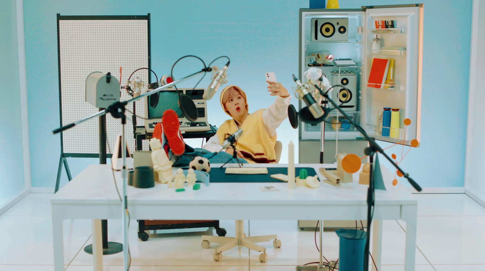 a child sitting at a table with a bunch of objects on it