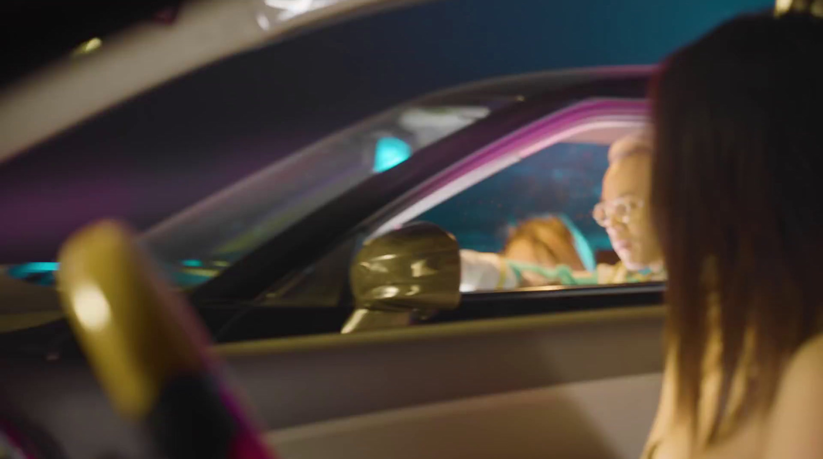 a woman sitting in a car looking out the window