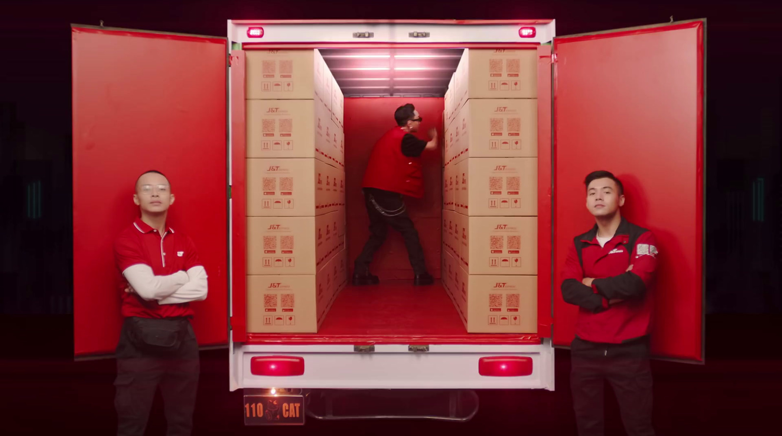 a couple of men standing in front of a red truck