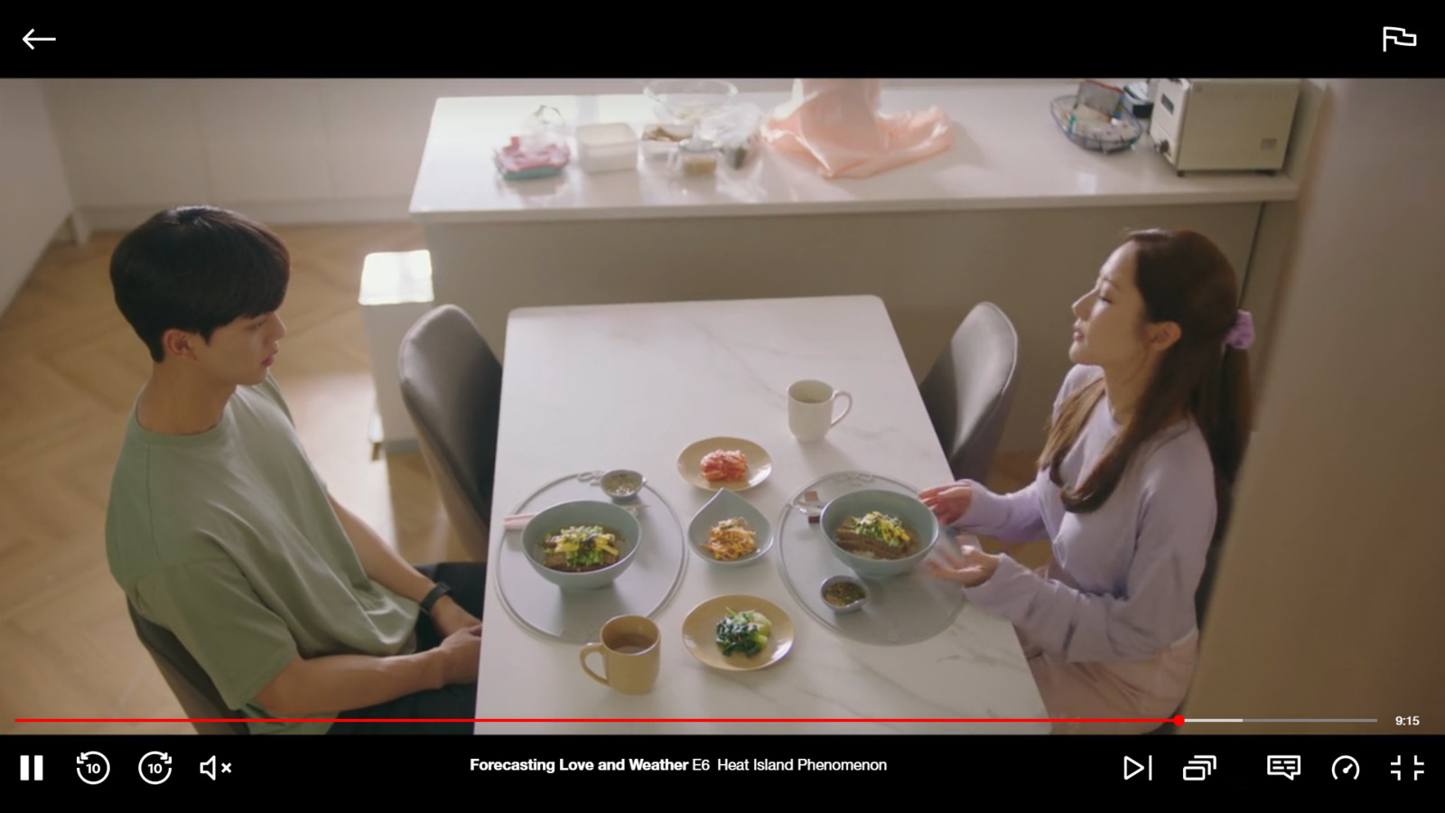 a man and woman sitting at a table with plates of food