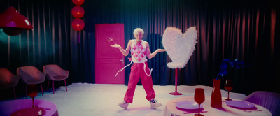 a woman standing in front of a pink door