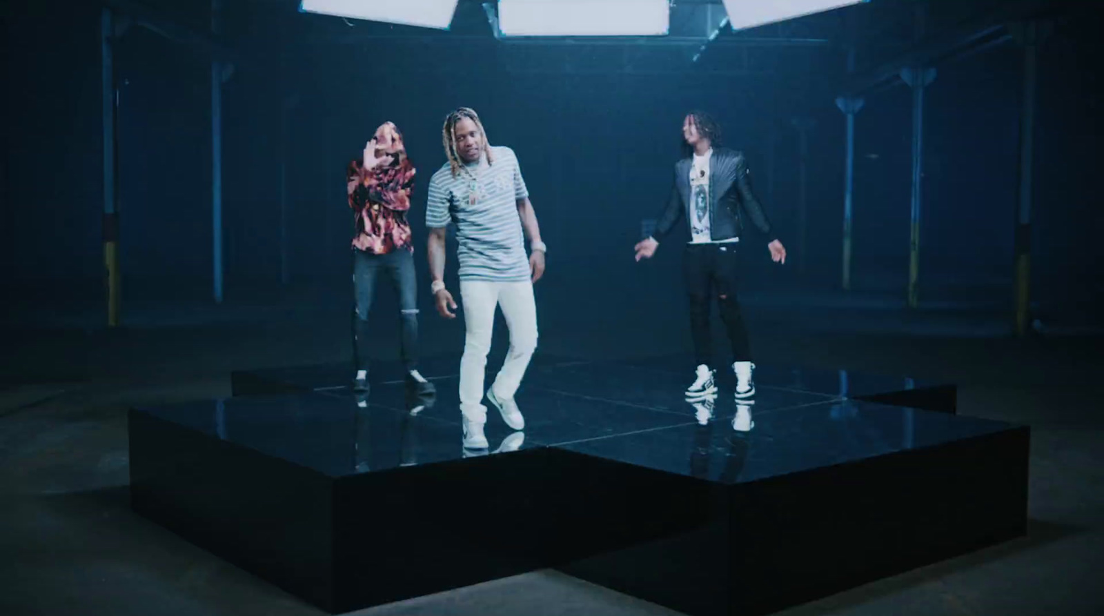 a group of people standing on top of a black table