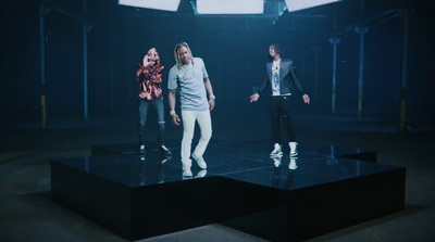 a group of people standing on top of a black table