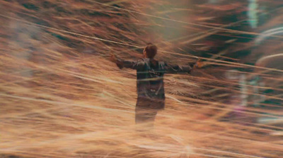 a blurry image of a man standing in a field