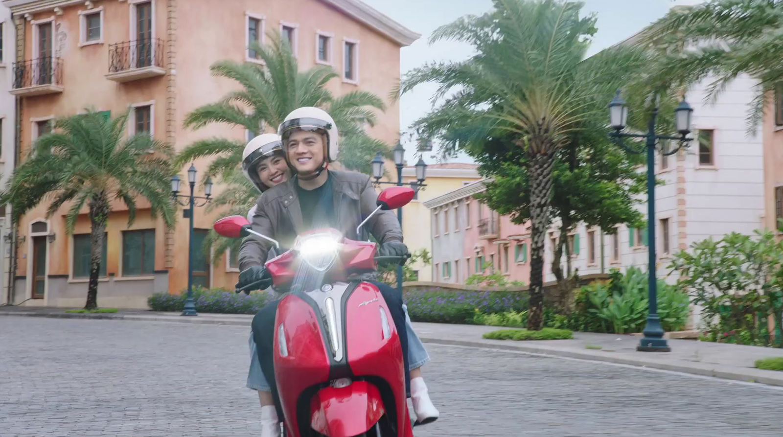 a man and a woman riding on the back of a red motorcycle