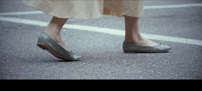 a close up of a person's shoes on the ground