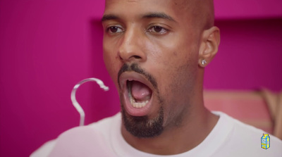 a man with his mouth open and a pair of ear buds in his mouth