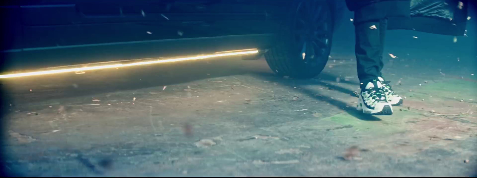 a person standing next to a car in the dark